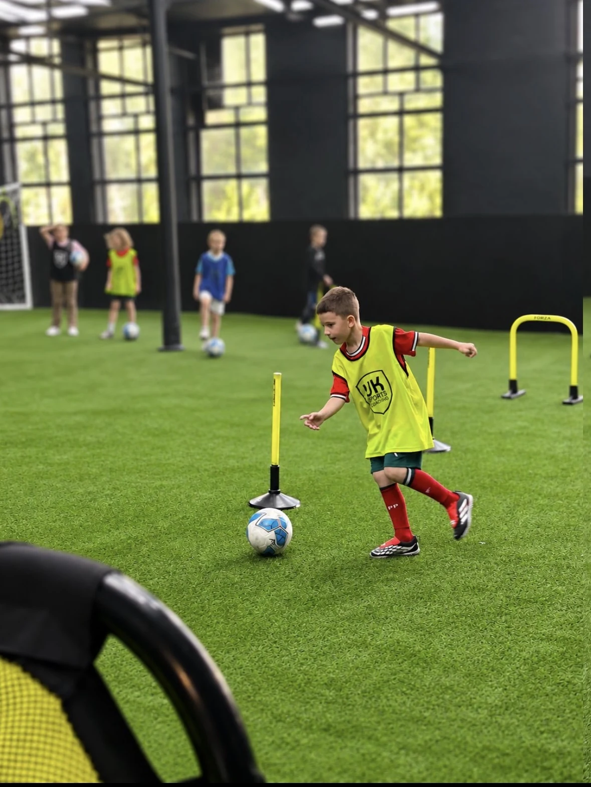 Child taking part in a UK Sports football birthday party activity in the arena