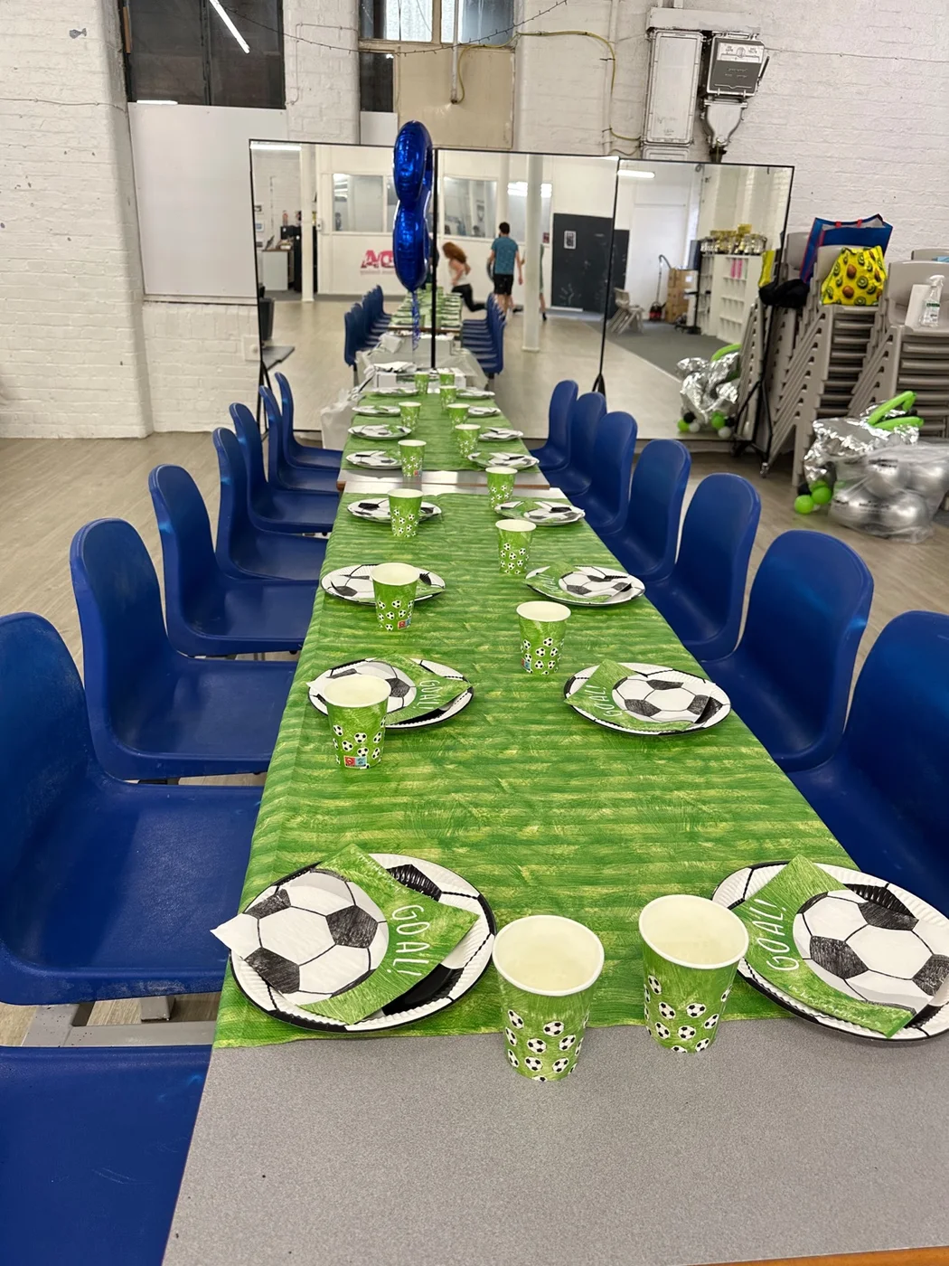 Birthday party table setup with football-themed decorations at UK Sports Coaching Ltd