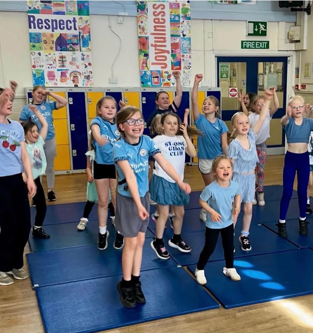 Children taking part in an energetic dance session delivered by UK Sports Coaching Ltd in a school hall