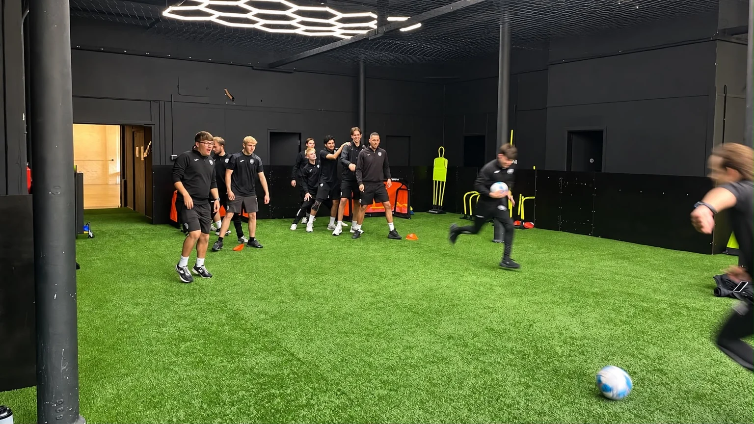 UK Sports coaching staff taking part in a practical football exercise inside the Arena
